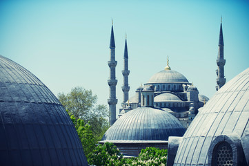 Dome-level view of the iconic minarets of the Blue Mosque from neighboring Hagia Sofia in Istanbul,...