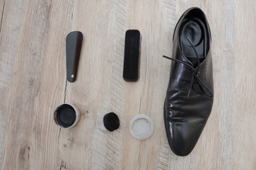 black men's shoes with accessories for care.