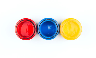  Cans of acrylic paint in blue, red and yellow on a white background. Artistic paints.