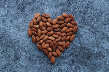 Heart-shaped almonds on a grey concrete table