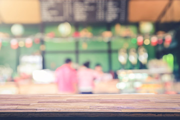 Wooden table top with view on Defocused customer at restaurant blurred background restaurant background blur cafe coffee shop