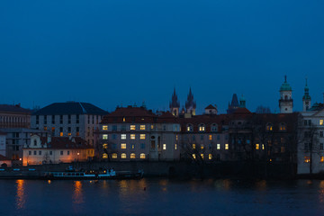 Fototapeta na wymiar Night panorama of Prague, the capital of the Czech Republic, the lights of the night medieval city and the Vltava river and beautiful Czech houses, as a vivid example of Gothic architecture