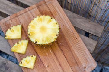 Pineapple slices on wooden table. Healthy food.