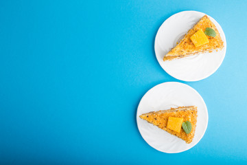 Homemade cake with persimmon and pumpkin on a blue background. top view, copy space.