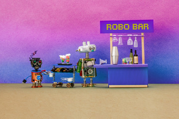 Funny restaurant staff characters, Robo Bar concept. Barman holding cocktail glass, waiter with a trolley and drinks, wine bottles. Two funny professional robots await guests. Pink blue background