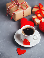 A Cup of hot coffee, red hearts and a gift for Valentine's day. Romantic morning