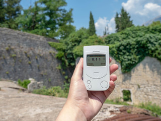 a geiger counter, a life, a radiation dosimeter, ancient, architecture, background, beta radiation, building, clean, control, defensive fort., device, device in hand, display, dosimeter, ecology, envi