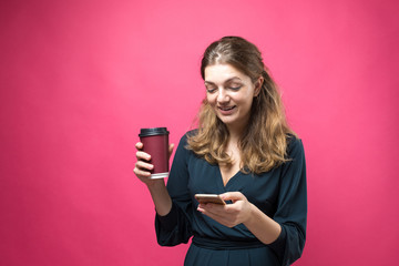 Glamor woman with a drink of coffee on a pink background.	