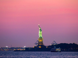 Liberty island, New York City [ Statue of Liberty on Hudson river during cruise sunset at dusk ]