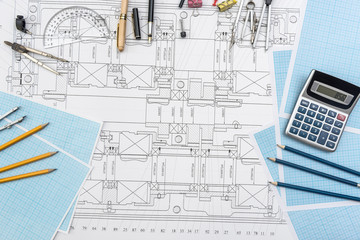 Paper with technical drawings and work tool on table. place of work.