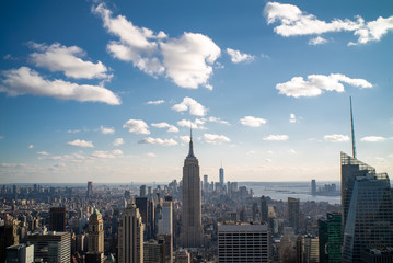 Fototapeta na wymiar Manhattan Skyline with blue sky and some clouds