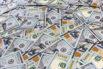 Background of many american one hundred dollar banknotes close up