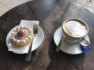 Sweet cake with cappuccino special cookies and extravagant peace and sugar round and extremely special and delicious and unhealthy food