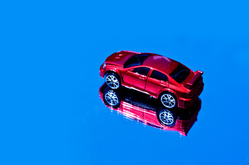 Red toy car on blue