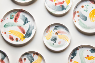 Hand-painted ceramic plates. Collection of colorful ceramic on white background