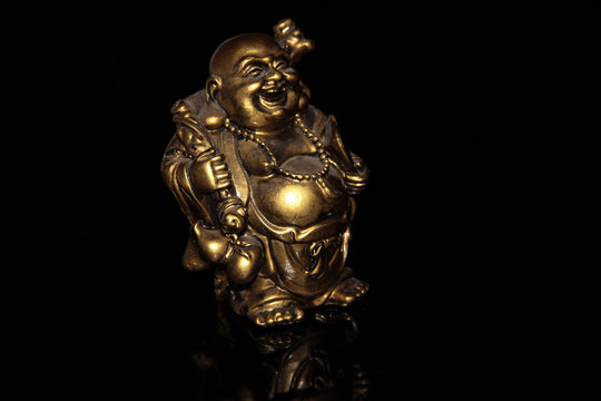 Laughing Buddha Hotei on a black background