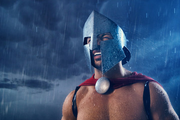 Spartan warrior in helmet in rain.