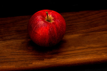 red apple  juicy   on wooden board  vegan