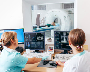 Nurse preparing patient for CT scan test in lab