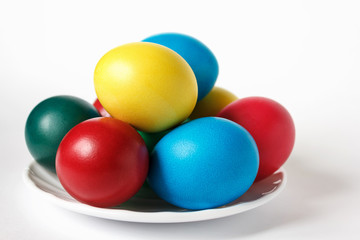 Colored easter eggs in white plate on a background. Isolate. White background.