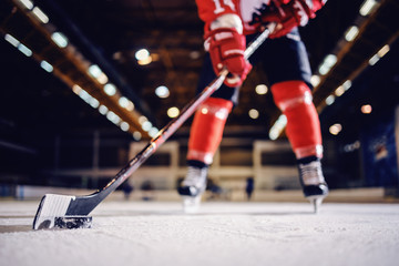 Close up of hockey player skating with stick and puck. - Powered by Adobe