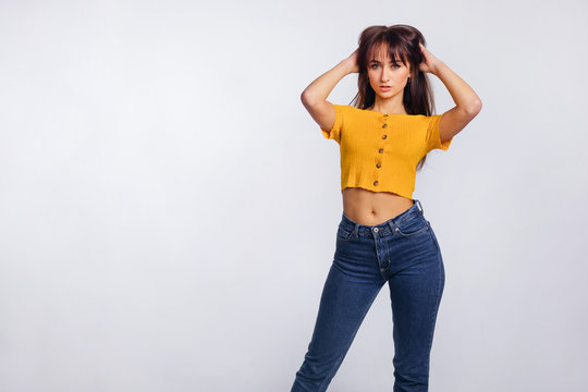 woman in yellow blouse and blue jeans, isolated on white. fashio