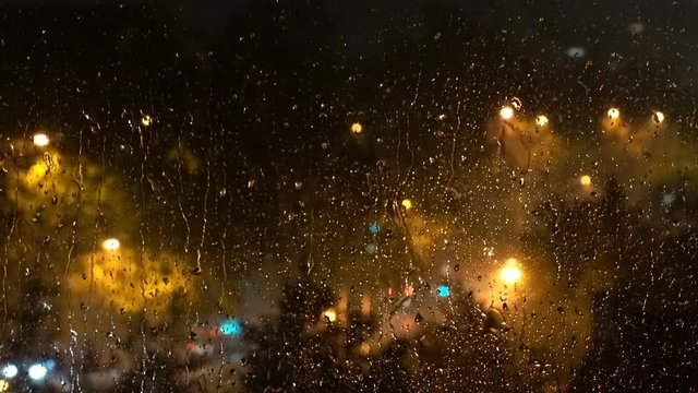 City Lights and Traffic on a Rainy Night  Through the Window with Raindrops