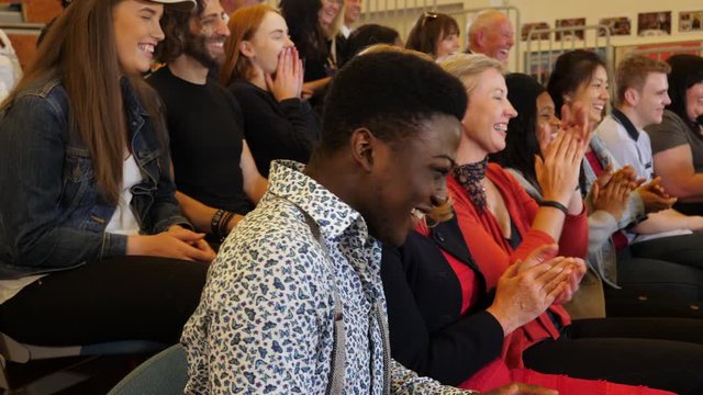 4K: Crowd laugh & Applaud - Group of people smiling indoors in a hall / auditorium - Stock 4K Video Clip Footage