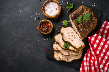 Baked pork meat ham on black kitchen table.