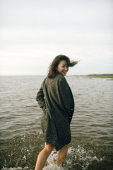Woman portrait in  coat on sea beach 