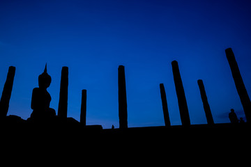 Silhouette of  Buddha image at Wat Mahathat in Sukhothai Historical Park, Thailand. Buddha statue used as amulets of Buddhism religion. Sukhothai Historic Park