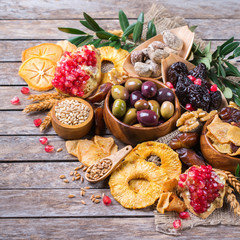 Tu Bishvat holiday symbols - dried fruits, pomegranate, barley, wheat