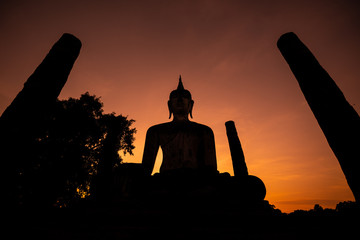 Silhouette of  Buddha image at Wat Mahathat in Sukhothai Historical Park, Thailand. Buddha statue used as amulets of Buddhism religion. Sukhothai Historic Park