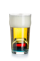 Depth charge cocktail of beer, blue Curacao liqueur, grenadine and vodka, prepared by mixing a submerged inverted Cup at the bottom of a beer glass. Ready-made cocktail.