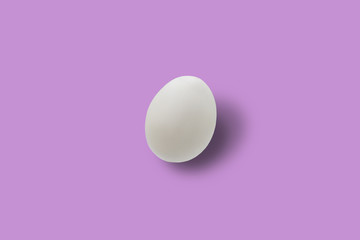 Easter white egg on pink background.