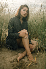 Woman portrait in  coat on sea beach 