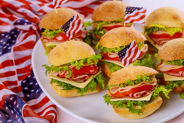 Tasty sandwiches with ham, tomato, cheese and lettuce for american holiday.