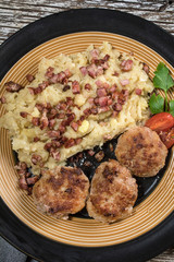 Mince chops served with boiled sauerkraut sprinkled with greaves.