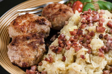 Minced meat cutlets with boiled sauerkraut.
