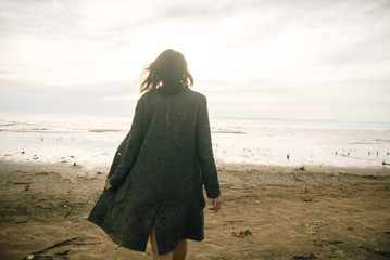 Woman portrait in  coat on sea beach 
