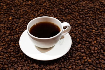 White  coffee mug on the coffee beans background