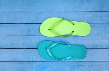 flip flops on wooden blue table