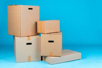 Stack of cardboard boxes on blue background