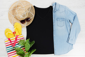T shirt black and slippers. T-shirt Mockup flat lay with summer accessories. Hat, yellow flip flops...
