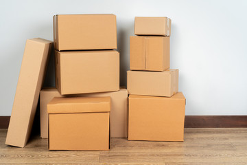 Group of brown carton boxes on wooden floor