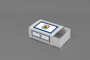 West Virginia flag on white box with barcode and the color of state flag on grey background, paper...