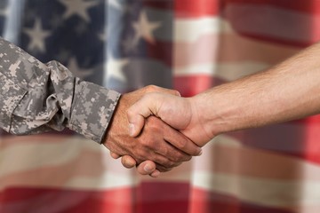 American soldier in uniform and civil man handshake