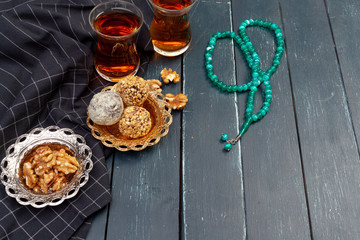 Nut balls dessert served with coffee on dark wooden table, top view
