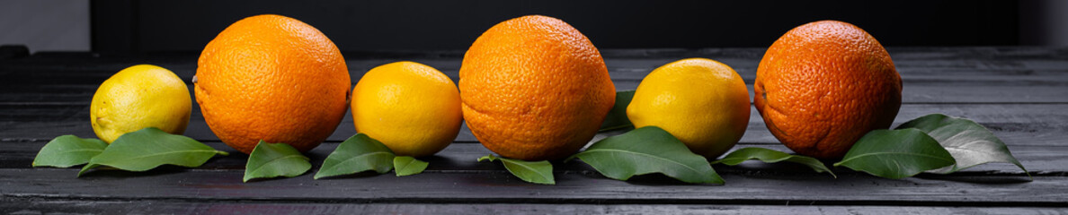 oranges and lemons on wooden table