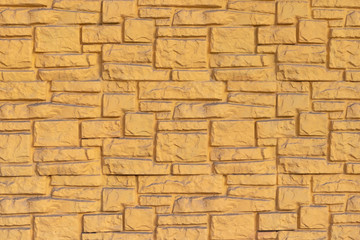 Facing of the building facade, painted with gold paint, background.